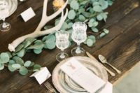 12 fresh eucalyptus and antlers plus an uncovered table are right what you need for a mountain wedding