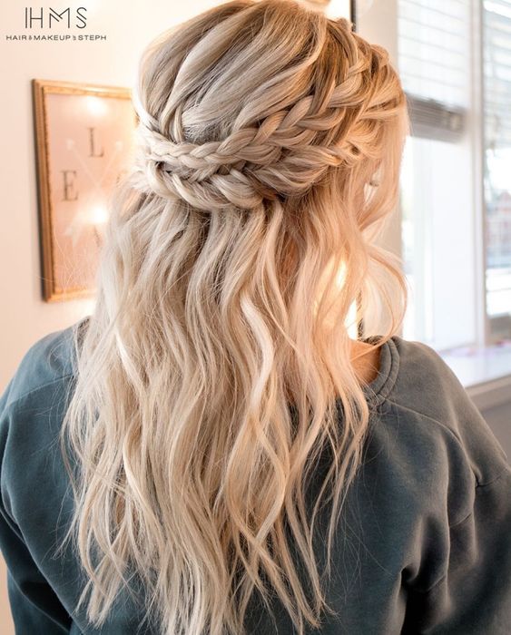 a half updo with a double braided halo and textural locks down for a boho chic bridesmaid