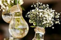 15 bulbs turned into little vases for baby’s breath and hung as a wedding decoration