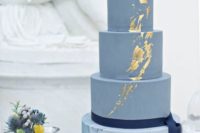 16 a blue wedding cake with a marble tier and touches of gold foil for a coastal wedding