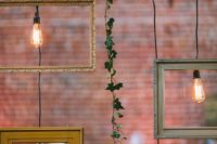 16 wedding decor with fresh greenery, frames and bulbs hanging down