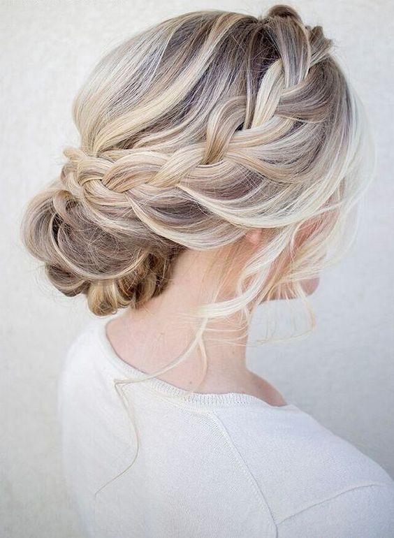 a chic braided halo with a low bun and waves down is great for a rustic or boho bridesmaid