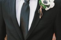 17 a modern Halloween groom’s look done with a blakc suit, tie, a white shirt and a white anemone boutonniere