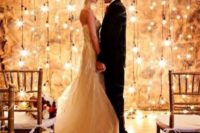 19 a backdrop made of hanging bulbs is a dreamy idea for any wedding
