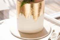 20 a chic white wedding cake with gold foil and succulents and blooms on top