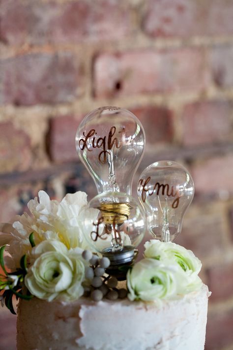 a light bulb cake topper with calligraphy is a creative idea for an industrial wedding