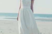21 a romantic vintage-inspired wedding dress with a lace applique bodice, short sleeves and a pleated skirt