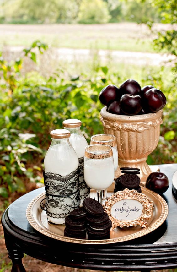 a stylish Tim Burton-inspired dessert table with milk, cookies and dark apples wows