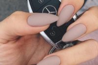 22 light grey matte manicure with a single statement nail done with rhinestones is a bold idea for a timeless look
