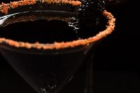 23 black devil martinis in glasses with food coloring to give them a creepy touch