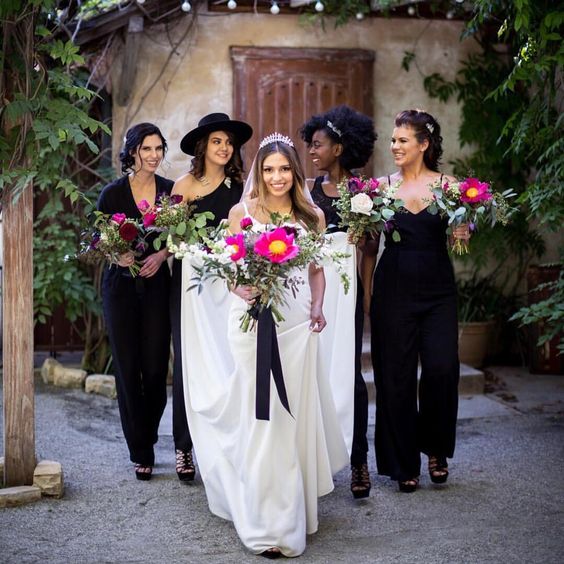 mismatching black jumpsuits and lacey black heels for all the bridesmaids
