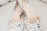 24 off-white pointed toe flats with large floral embellishments for a romantic feel