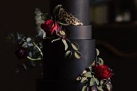 25 a matte black wedding cake with a touch of gold and sugar burgundy blooms and greenery