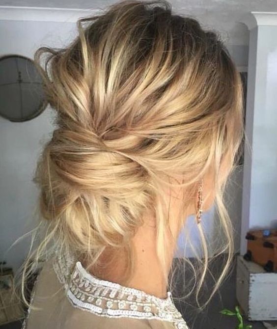 a super messy low bun with locks down and a bump is an effortlessly chic hairstyle