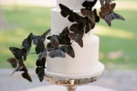 25 a white wedding cake decorated with large black butterflies for a timelessly elegant look