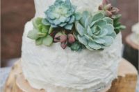 26 a rough wood stump cake stand highlight the uneven texture of the wedding cake