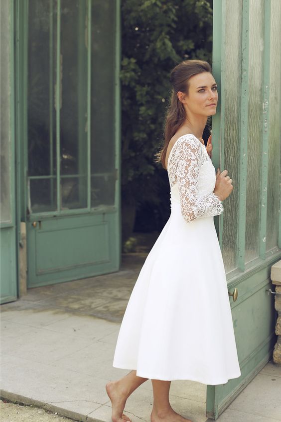 a vintage-inspired midi wedding gown with a lace illusion bodice and a plain full skirt, bell sleeves