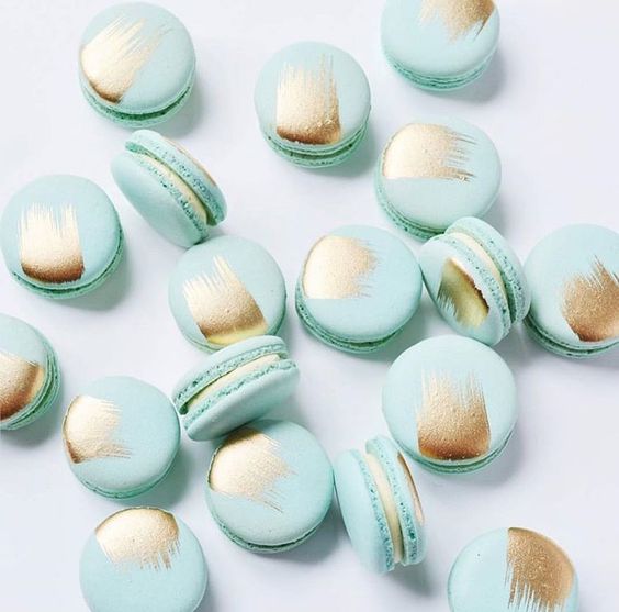 mint macarons with touches of gold foil are a tasty and cool-looking dessert