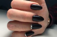 31 shiny black nails with rhinestones are a nice idea to make a statement or for a Halloween bride