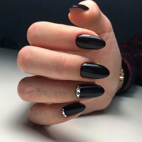 shiny black nails with rhinestones are a nice idea to make a statement or for a Halloween bride