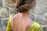a beautiful braided and twsited low updo with a sleek top is a cool solution for a modern bride or bridesmaid