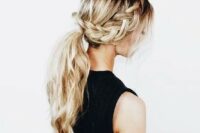 a braid going into a low ponytail with waves and locks down for a boho look, for a bride or bridesmaid