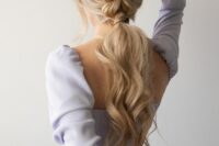 a braided ponytail with waves and face-framing locks is a comfortable to wear hairstyle for a bridesmaid