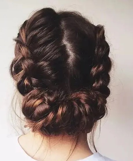 a cool braided low updo with a texture looks cool for a rustic or boho wedding
