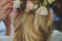 a half updo with twists and waves, with frehs neutral and pastel blooms tucked in is a great idea for a spring or summer boho bride