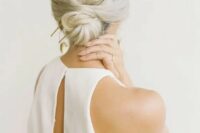 a low bun with a bump and an oversized gilded accessory is ideal for a minimalist bride or bridesmaid