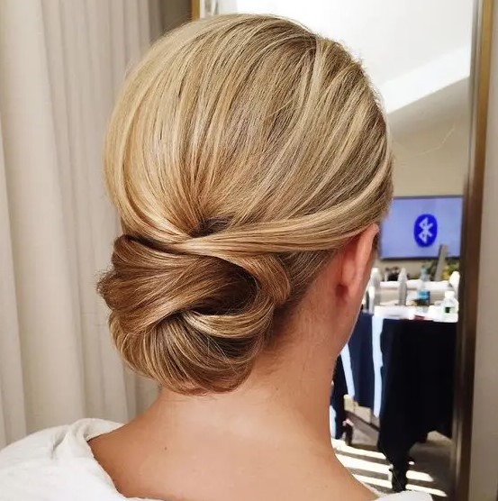 a low twisted chignon looks interesting and non-typical, perfect for an elegant look, it's great for brides and bridesmaids