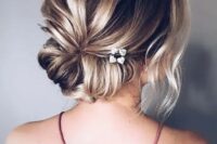 a low twisted chignon with a bump, some locks down and little blooms tucked in is great for a bride or bridesmaid