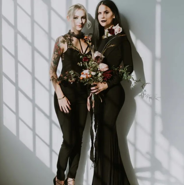 a mermaid bridesmaid gown with long sleeves and a jumpsuit with lace details on top for a modern Halloween wedding