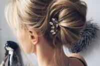 a messy chignon hairstyle with bangs and a rhinestone hairpiece for a modern casual bride or bridesmaids