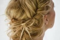 a messy low updo with large braids and a messy volume on top is a gorgeous idea for a boho or just relaxed laid-back bride