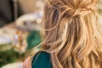a messy twisted wavy half updo on long hair is a great relaxed idea that will easily match many wedding styles