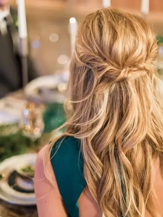 a messy twisted wavy half updo on long hair is a great relaxed idea that will easily match many wedding styles