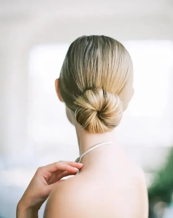 a minimalist sleek ballet bun is a chic statement for a minimal bride or bridesmaid to rock on a big day