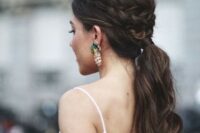 a wavy ponytail with a bump and a braided halo for a casual and modern bride or bridesmaid