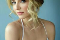 a wavy updo with a braided halo is a chic and timeless idea for a boho, rustic or just romantic bride