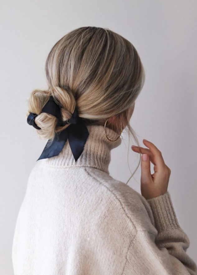 an elegant low bun interwoven with a black ribbon is a very chic idea, suitable for many styles