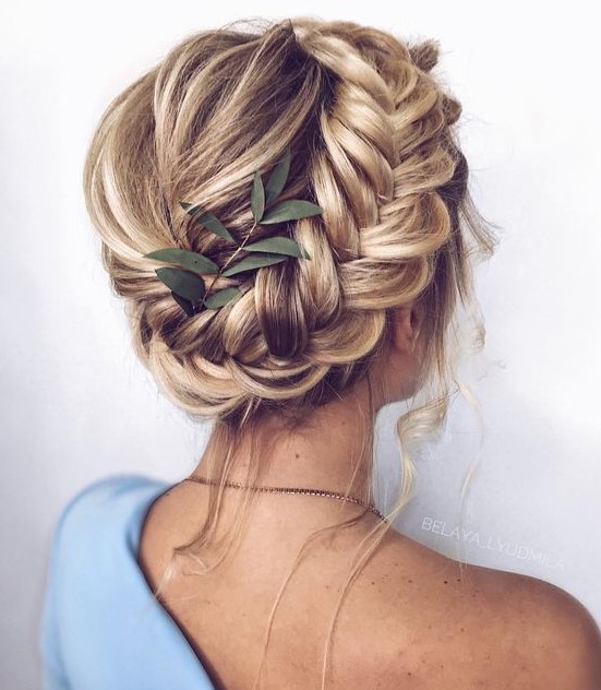an updo with a bump and a dimensional side braid plus some locks down is a chic idea