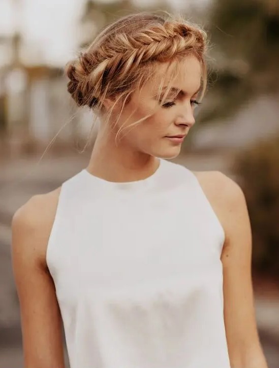 an updo with a fishtail braid on the side and some locks down is a modern and simple idea