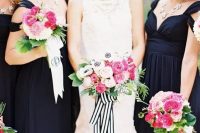 chic black maxi dresses for the bridesmaids and the bride in a sleeveless lace wedding dress