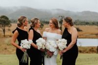 elegant black one shoulder bridesmaid dresses with bows on the shoulders, slits and trains for a formal wedding