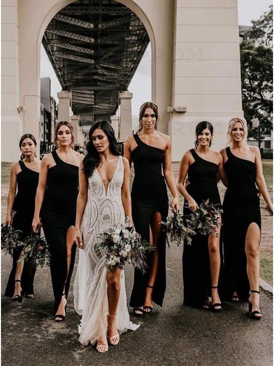 lovely maxi black bridesmaid dresses with thigh high slits an one shoulder necklines, black shoes for a boho wedding
