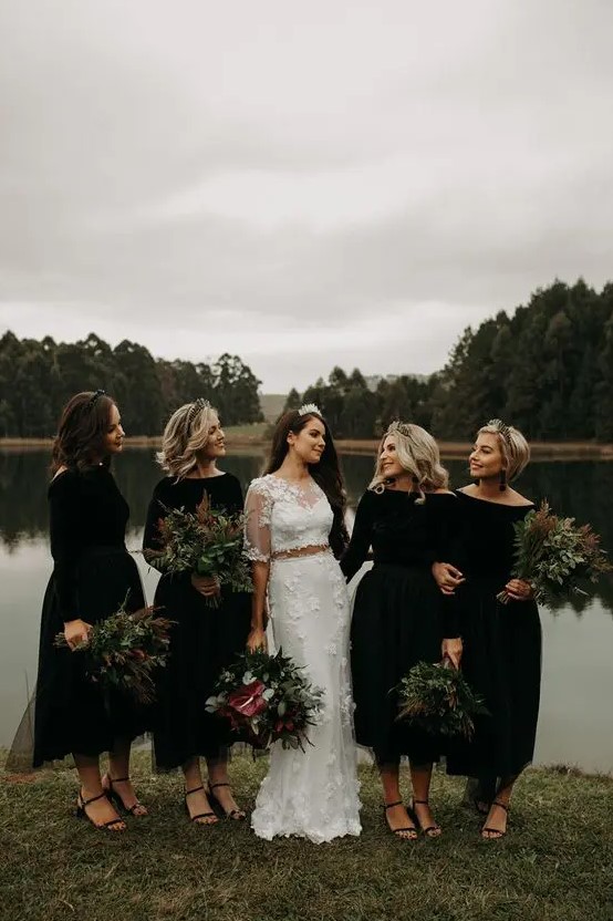 matching black midi bridesmaid dresses with bateau necklines, long sleeves and black shoes for Halloween