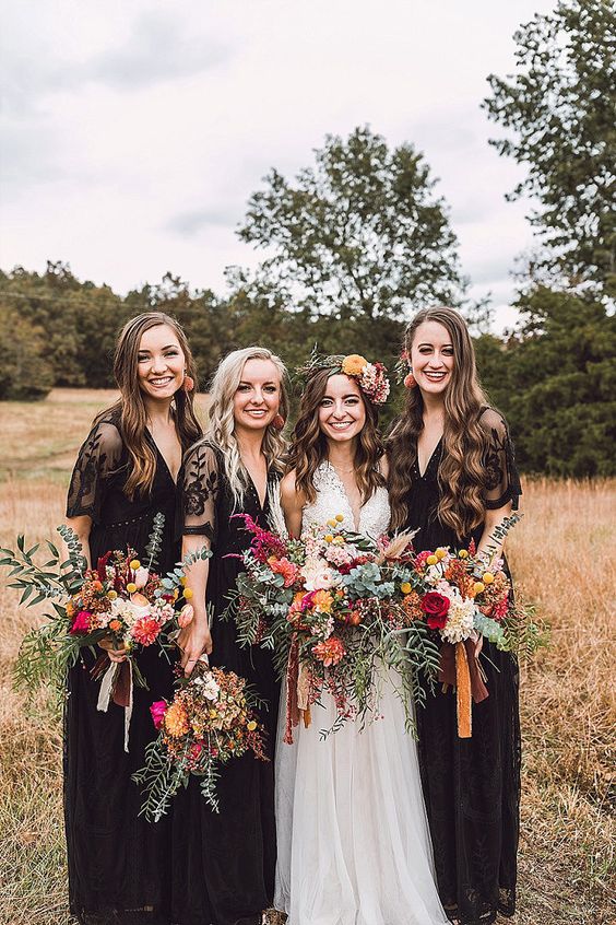Maxi black bridesmaid dresses with lace sleeves and V necklines are perfect for a fall boho wedding