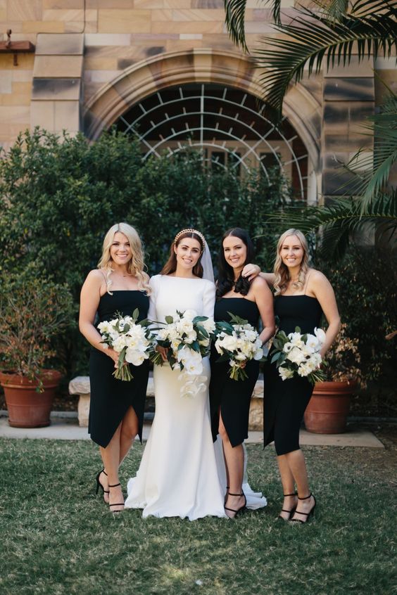 midi black bridesmaid dresses with spaghetti straps and black strappy shoes for a modenr or minimalist wedding