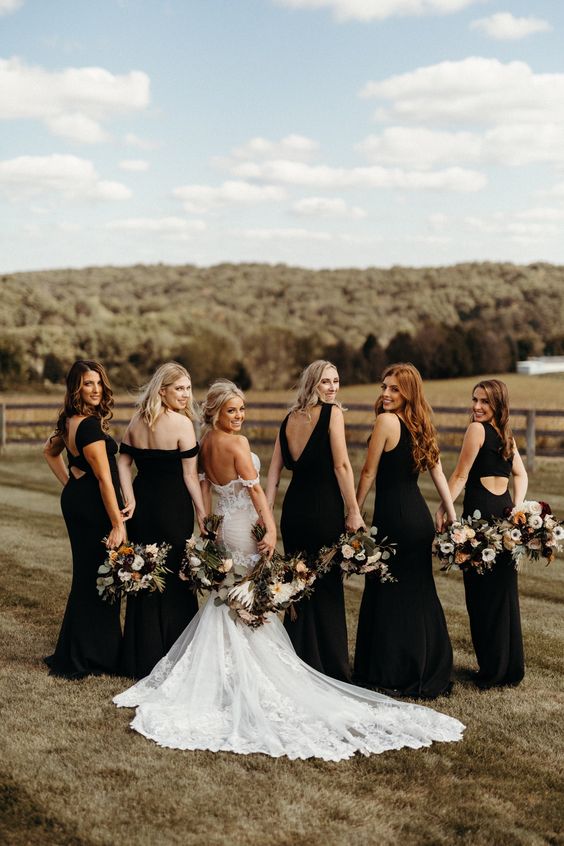 mismatched maxi black bridesmaid dresses with mermaid silhouettes are amazing for a chic boho wedding